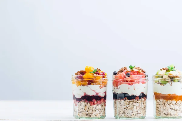 Oatmeal with fruit and cereals in a glass jar