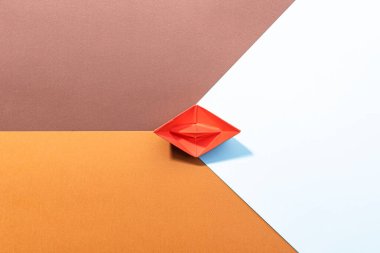 small red paper boat on a paper background. conceptual abstract image of the female genital organs of the vagina. clipart