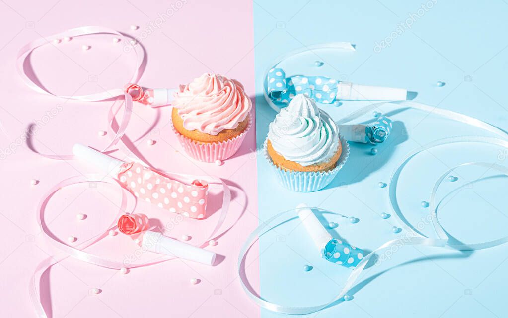 gender party. boy or girl. two cupcakes with blue and pink cream, celebration concept when the gender of the child becomes known