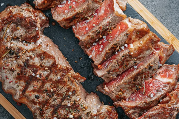 juicy fresh fried steaks for dinner. two fried striploin steak in a medium roasting rare