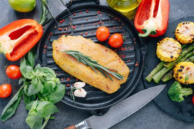 Baharatlı ve zeytinyağlı çiğ hindi filetosu, ızgaraya hazır.