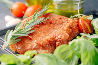 Baharatlı çiğ domuz eti, zeytinyağı ve fesleğen sosu.