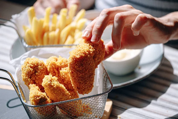 fast food. chicken wings in crispy batter. delicious and juicy appetizing food in a fast food cafe