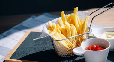 delicious and hot fries with different sauces