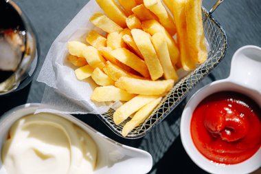delicious and hot fries with different sauces