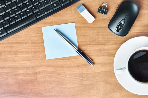 Business desk and a cup of coffee — Stock Photo, Image