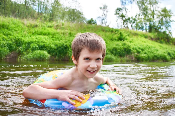 Happy boy bathes in river on summer day — Stock Photo, Image