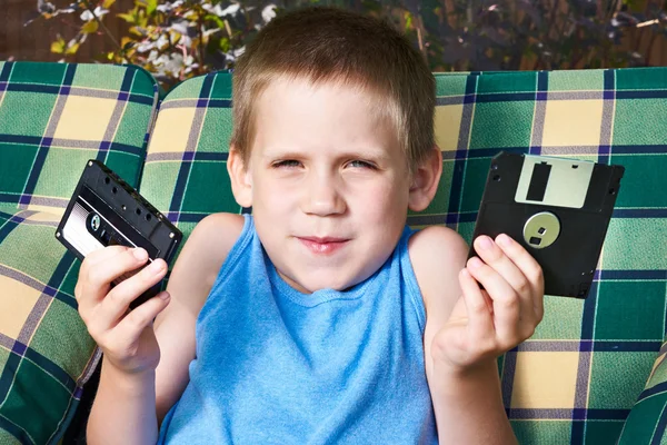 Мальчик с дискетой и аудиокассетой — стоковое фото