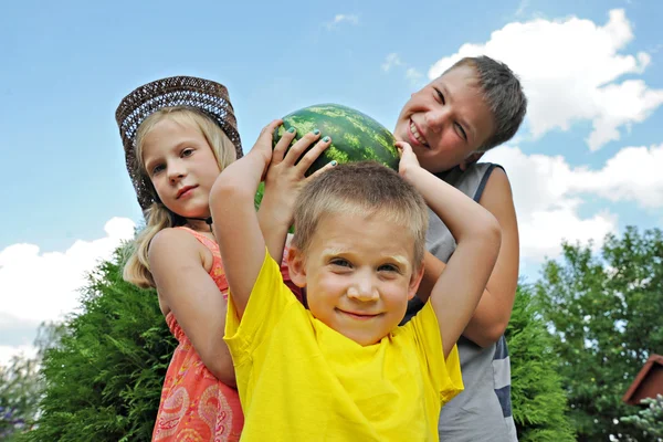 Happy children with a big watermelon — Stock Photo, Image