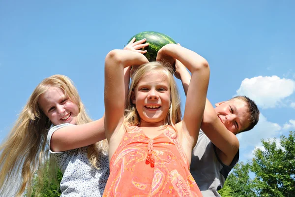 Happy children with a big watermelon — Stock Photo, Image