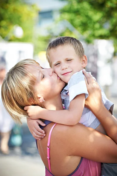 Happy mother kisses her son — Stock Photo, Image