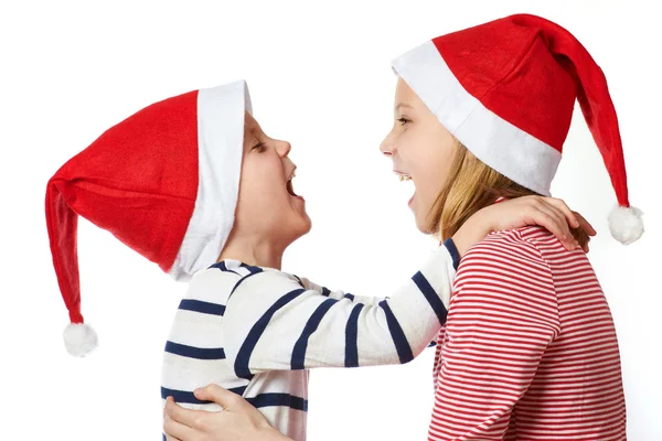 Ragazza e bambino in cappello di Babbo Natale — Foto Stock