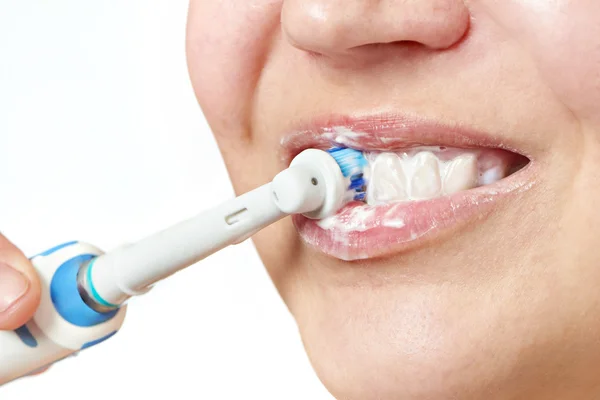 Woman brushing teeth electric toothbrush closeup isolated — Stock Photo, Image
