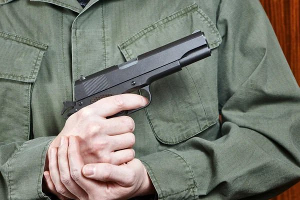 Soldado de uniforme segurando arma Colt — Fotografia de Stock