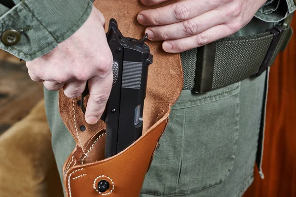 Soldier takes out gun from the holster — Stock Photo, Image