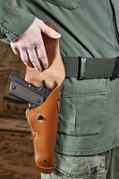 Soldier opens pistol holster — Stock Photo, Image