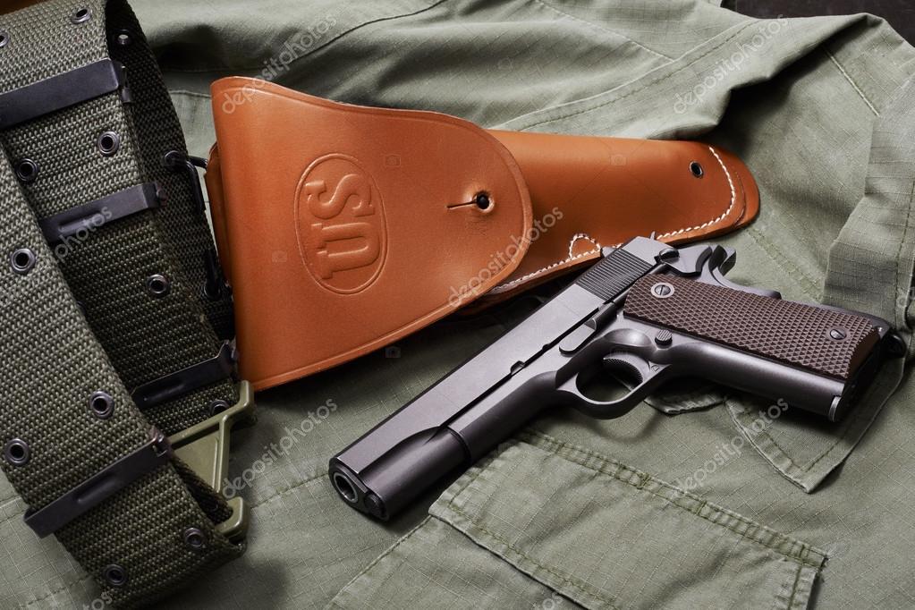 Colt gun pistol, holster and belt lie on military jacket Stock Photo by  ©ryzhov 64045161