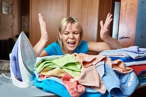 Angry and tired woman housewife from ironing board — Stock Photo, Image