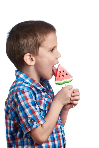 Little boy eating a lollipop watermelon — Stock Photo, Image