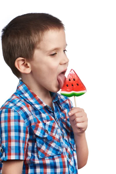 Little boy eating a lollipop watermelon — Stock Photo, Image