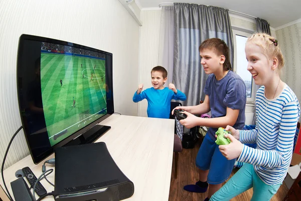 Children playing on games console to play football — Stock Photo, Image