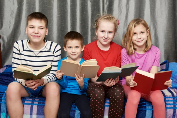 Niños sentados y leyendo libros en casa — Foto de Stock