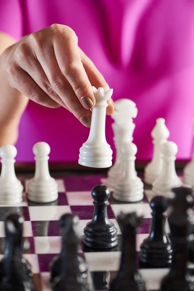 Hand with white queen over chessboard — Stock Photo, Image