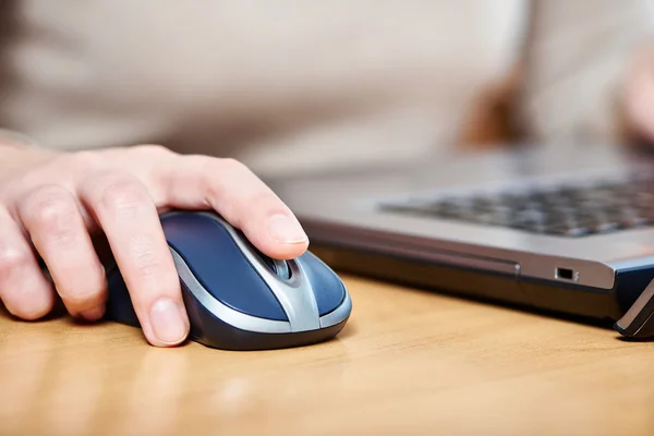 Female hand touching computer mouse — Stock Photo, Image