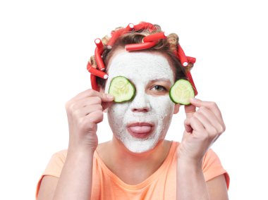 Young woman in curlers and with a mask on her face clipart