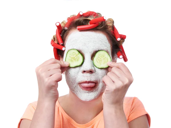 Young woman in curlers and with a mask on her face — Stock Photo, Image