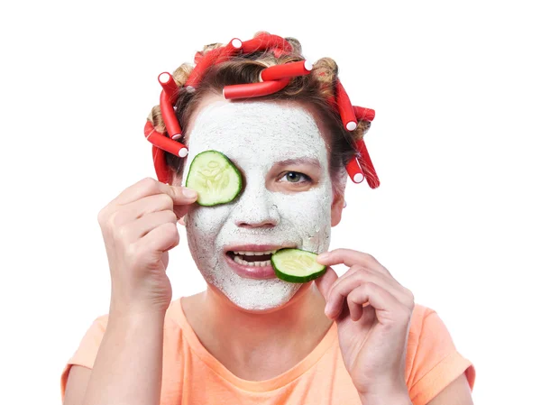 Young woman in curlers and with a mask on her face — Stock Photo, Image