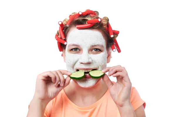 Young woman in curlers and with a mask on her face — Stock Photo, Image