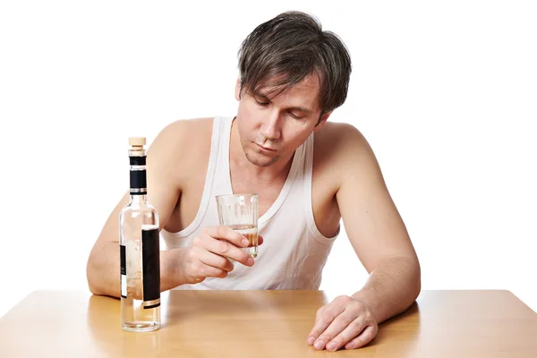 Dronken man met fles wodka en een glas — Stockfoto