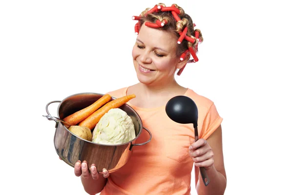 Happy housewife with pan vegetables — Stock Photo, Image