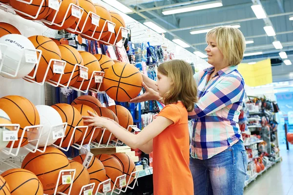 Mother and daughter shopping basketball ball