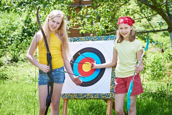 Girls with bow near sport aim — Stock Photo, Image