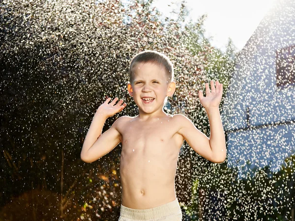 Happy little boy under rain — Stock Photo, Image