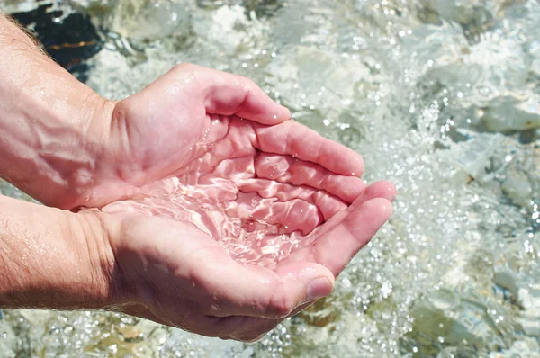 Havsvatten i handflatorna av man — Stockfoto