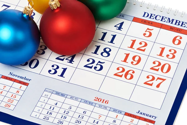 Christmas balls on calendar — Stock Photo, Image