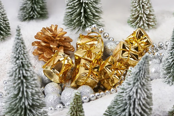 Gifts in gold packaging near toys trees — Stock Photo, Image