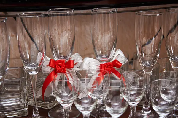 Champagne glasses decorated with red bows — Stock Photo, Image