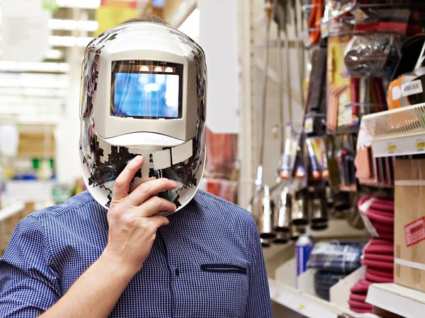 Mężczyzn wybrać ochronne maski spawacza w sklepie budowlane i narzędzia — Zdjęcie stockowe