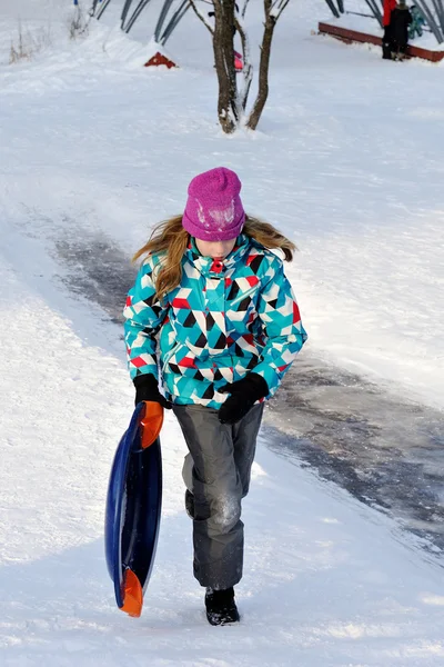 Girl riding with hills on sleds — Stock Photo, Image