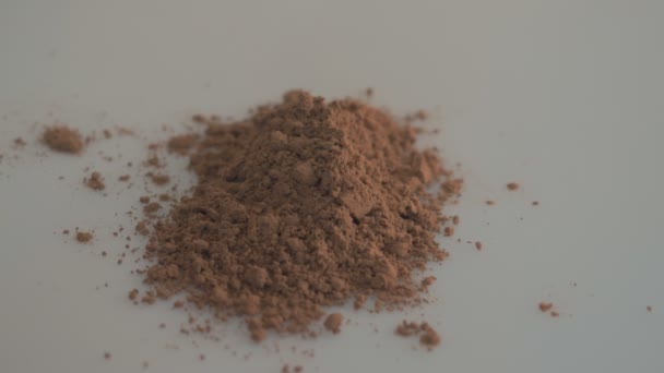Cocoa powder on white background — Stock Video
