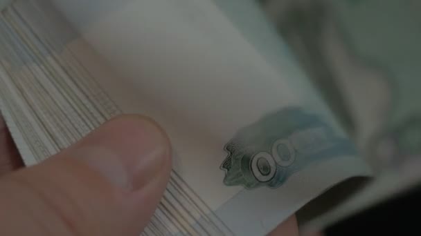 Money in Russia. Banknotes one thousand rubles. Flipping banknotes. Black background. — Stock Video