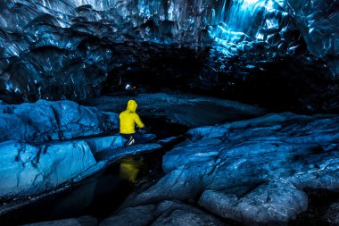 Tourist at glacier cave clipart
