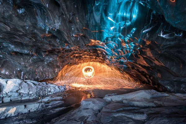 Fire show in the ice cave — Stock Photo, Image