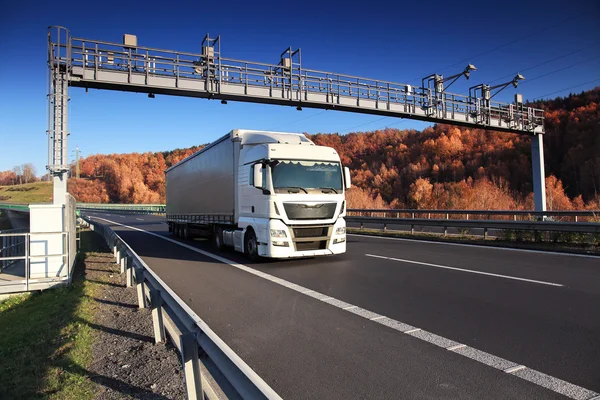 Truck transportation on the road under the toll gate — Stock Photo, Image