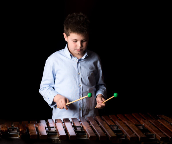 Boy playing on xylophone