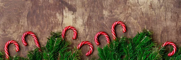 Christmas Background Candy Canes Fir Tree Branches Wooden Table Top — Stock Photo, Image